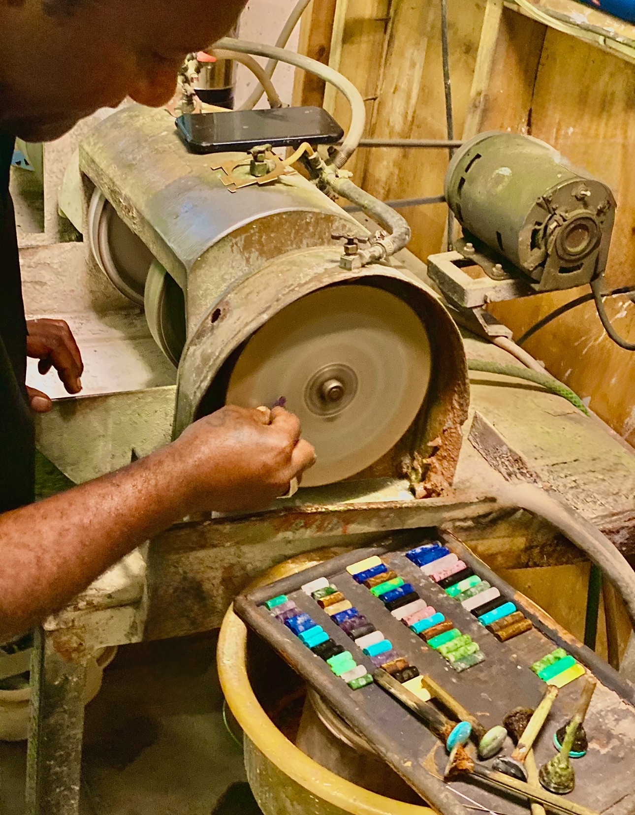 A master jeweller polishing a piece at the atelier bench